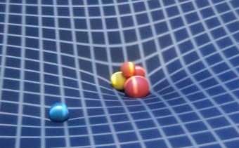 Toile tendue déformée par des boules plus ou moins grosses, illustrant sur une surface à deux dimensions l'idée de la relativité générale.